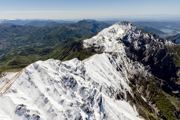 Aerial view of the snowy ridges of Grignetta and Resegone with the lake in the background Lecco Province Lombardy Italy Europe