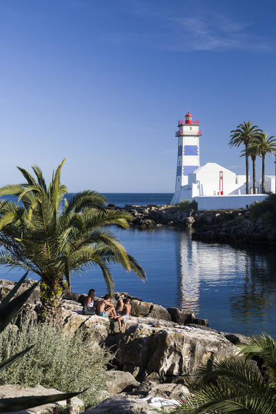 The lighthouse reflected in the blue water under the blue summer sky Cascais Estoril Coast Lisbon Portugal Europe