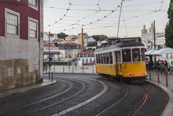 Romantic atmosphere in the old streets of  Alfama with the castle in the background and tram number 28 Lisbon Portugal Europe