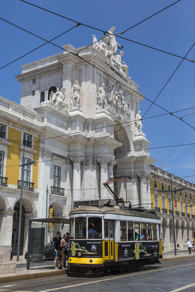 A typical tram passes by the historical Praca Do Comercio square near the Tagus river Lisbon Estremadura Portugal Europe
