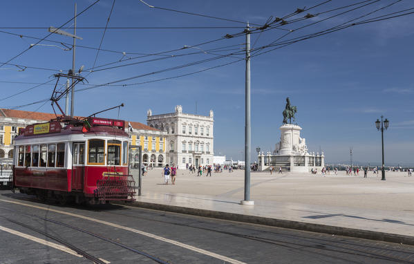 A typical red tram stops at the historical Praca Do Comercio square near the Tagus river  Lisbon Estremadura Portugal Europe