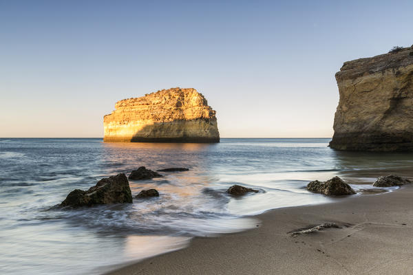 Dawn on the cliffs and turquoise water of Praia De Albandeira Carvoeiro Caramujeira Lagoa Municipality Algarve Portugal Europe