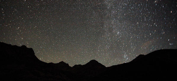 Billions of stars draw the night sky in Montespluga. Valchiavenna. Vallespluga. Lombardy. Italy. Europe