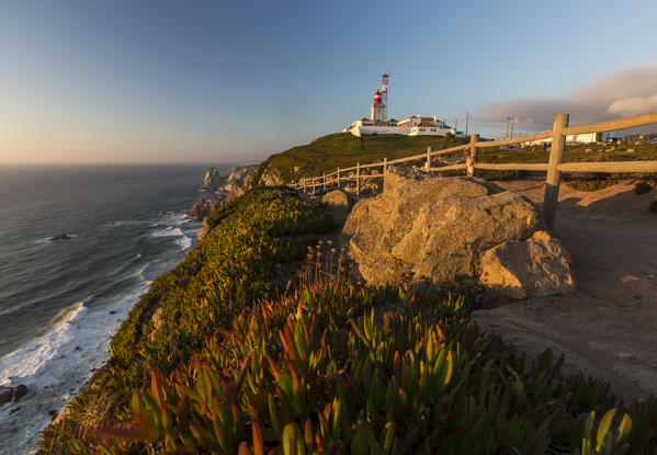 The Cabo da Roca lighthouse overlooks the promontory towards the Atlantic Ocean at  sunset Sintra Portugal Europe