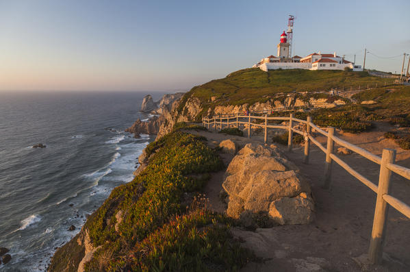 The colors of the sunset on the cape and lighthouse of Cabo da Roca overlooking the Atlantic Ocean Sintra Portugal Europe