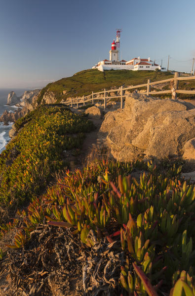 The Cabo da Roca lighthouse overlooks the promontory towards the Atlantic Ocean at  sunset Sintra Portugal Europe