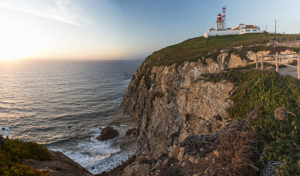 The colors of the sunset on the cape and lighthouse of Cabo da Roca overlooking the Atlantic Ocean Sintra Portugal Europe