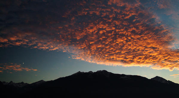 The amazing colours of a sunset in lower Valtellina, Orobie Alps Lombardy Italy Europe