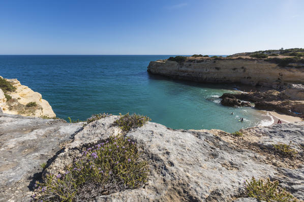 The turquoise water of the ocean surrounded by cliffs at Praia De Albandeira Algarve Lagoa Faro District Portugal Europe