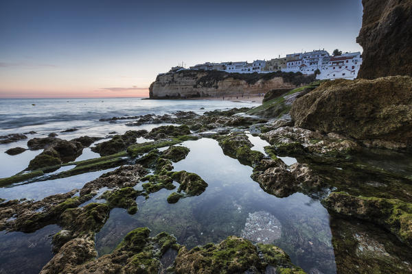 Sunset on the village perched on the promontory overlooking the beach of Carvoeiro Algarve Lagoa Faro District Portugal Europe