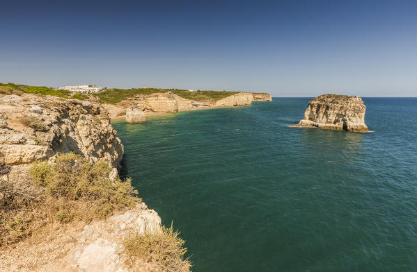 The turquoise waters of the ocean frames the sandy beach around Praia do Torrado Algarve Lagoa Faro District Portugal Europe