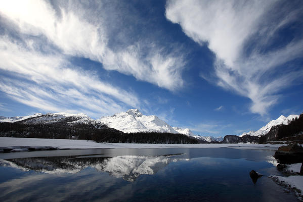 Some picturesque clouds above the lake of Sils an in the background piz de la Margna, highe Engadine, Switzerland Europe