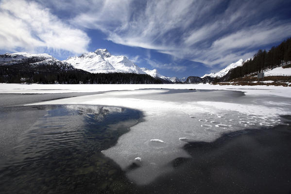 Strange clouds in the sky above the lake of Sils and in the background Piz De La Margna, Engadine, Switzerland Europe