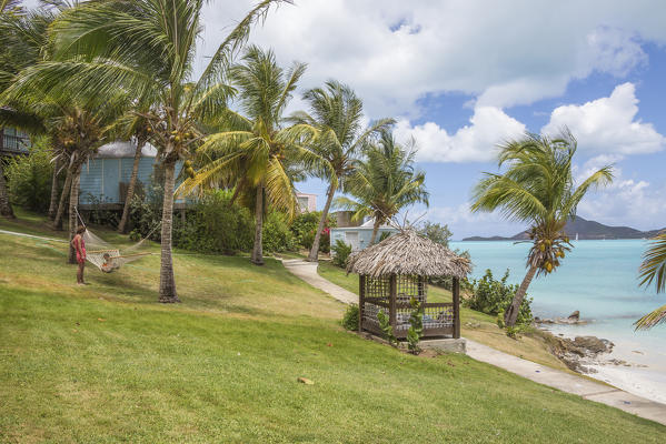 Palm trees and gardens surrounded by Caribbean Sea Ffryes Beach Sheer Rocks Antigua and Barbuda Leeward Island West Indies