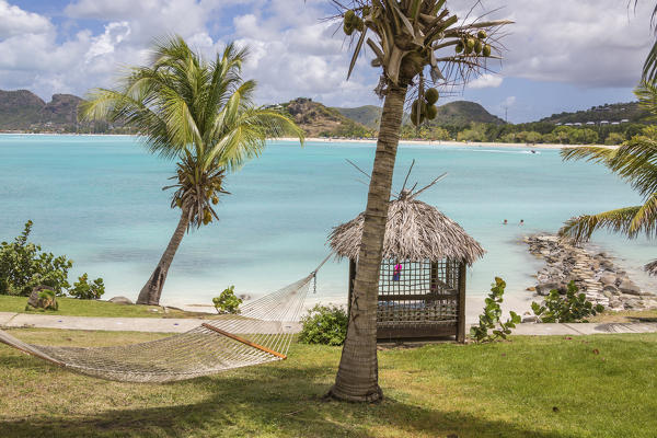 Hammock and palm trees surrounded by the Caribbean Sea Ffryes Beach Sheer Rocks Antigua and Barbuda Leeward Island West Indies