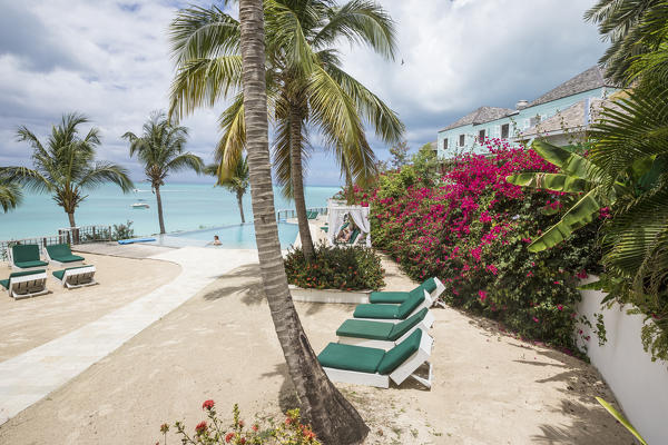 Sunbeds and palm trees overlooking the Caribbean Sea Ffryes Beach Sheer Rocks Antigua and Barbuda Leeward Island West Indies