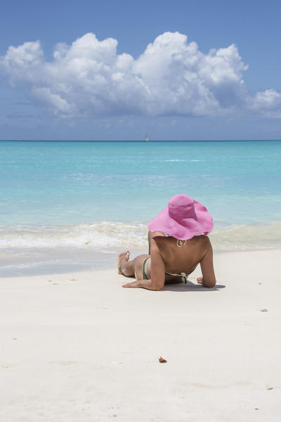Tourist admires the turquoise Caribbean Sea Jolly Beach Antigua and Barbuda Leeward Island West Indies