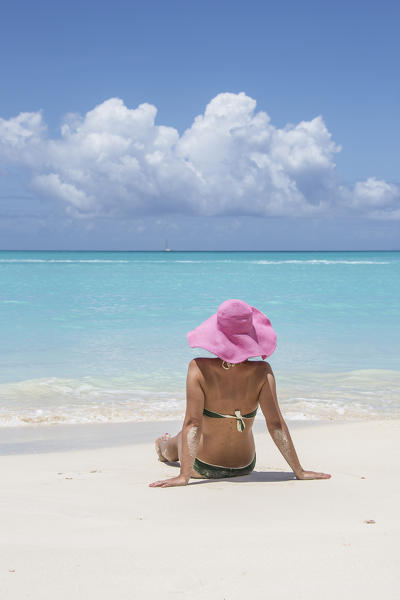 Tourist admires the turquoise Caribbean Sea Jolly Beach Antigua and Barbuda Leeward Island West Indies