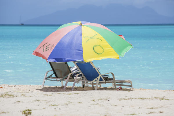Sunbeds and beach umbrellas at Jolly Beach Caribbean Antigua and Barbuda Leeward Island West Indies