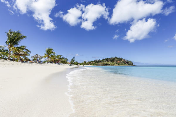 Palm trees and white sand surround the turquoise Caribbean sea Ffryers Beach Antigua and Barbuda Leeward Islands West Indies