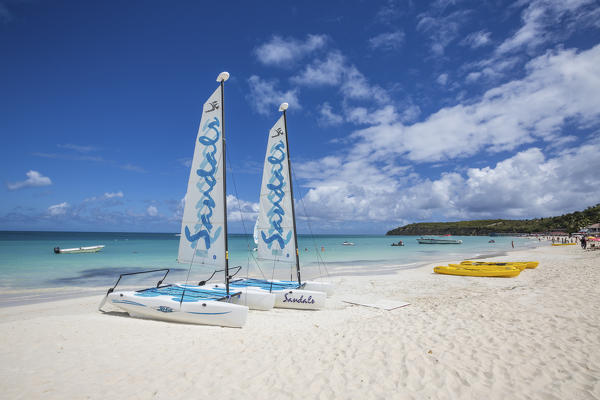 Catamarans on the beach ready to sail in the blue Caribbean Sea Dickenson Bay Antigua and Barbuda Leeward Island West Indies