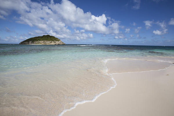 Blue sky frames the white sand and the turquoise Caribbean sea Half Moon Bay Antigua and Barbuda Leeward Island West Indies