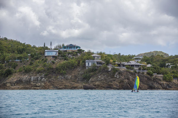 The Caribbean sea and a tourist resort seen from a boat tour in a cloudy day Antigua and Barbuda Leeward Islands West Indies