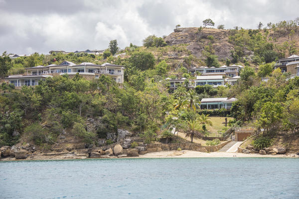 The turquoise Caribbean sea and a tourist resort seen from a boat tour Antigua and Barbuda Leeward Islands West Indies