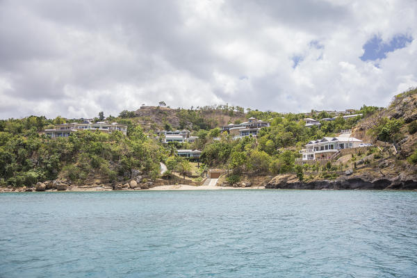 The turquoise Caribbean sea and a tourist resort seen from a boat tour Antigua and Barbuda Leeward Islands West Indies