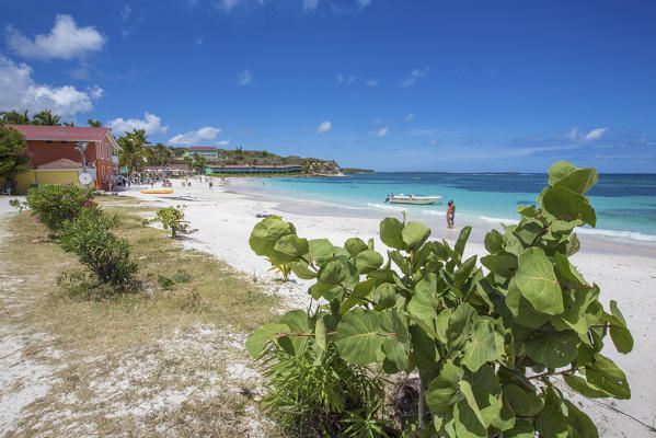 White sand and tourists frame the turquoise Caribbean sea at Long Bay Beach Antigua and Barbuda Leeward Islands West Indies