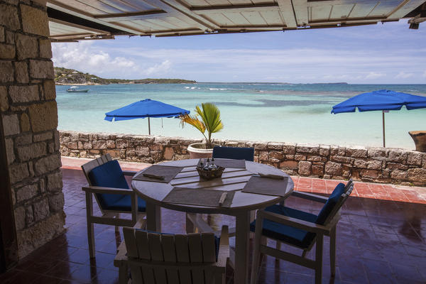 View of the turquoise Caribbean Sea from a dining table of a resort Long Bay Antigua and Barbuda Leeward Islands West Indies