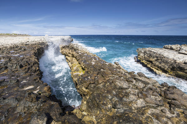 Waves in the natural arches of limestone carved by sea Devil's Bridge Caribbean Antigua and Barbuda Leeward Islands West Indies