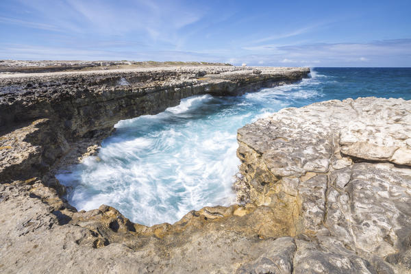 Waves in the natural arches of limestone carved by sea Devil's Bridge Caribbean Antigua and Barbuda Leeward Islands West Indies