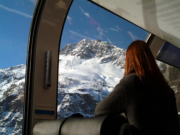 Enjoying the view  of the mountains in Val Poschiavo from a panoramic window of the Bernina Express, Switzerland Europe