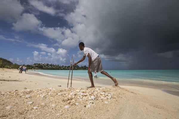 Kids playing on the beach surrounded by the turquoise Caribbean sea The Nest Antigua and Barbuda Leeward Islands West Indies