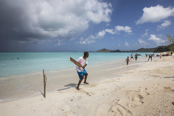 Kids playing on the beach surrounded by the turquoise Caribbean sea The Nest Antigua and Barbuda Leeward Islands West Indies