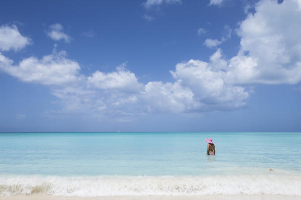 A bather with a pink hat in the turquoise waters of the Caribbean Sea The Nest Antigua and Barbuda Leeward Islands West Indies