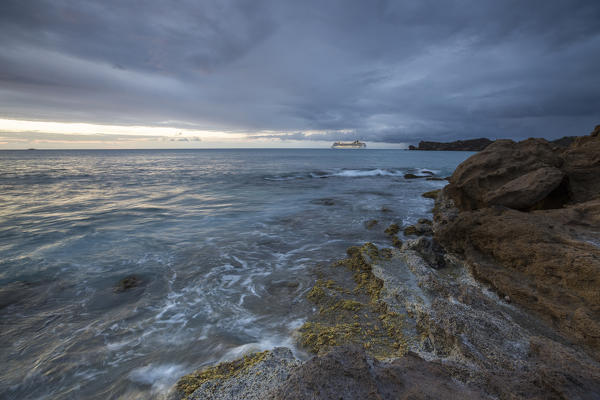 Dusk frames the waves crashing on the cliffs Galley Bay Caribbean St. John's Antigua and Barbuda Leeward Islands West Indies