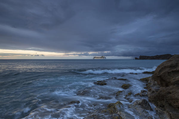 Dusk frames the waves crashing on the cliffs Galley Bay Caribbean St. John's Antigua and Barbuda Leeward Islands West Indies