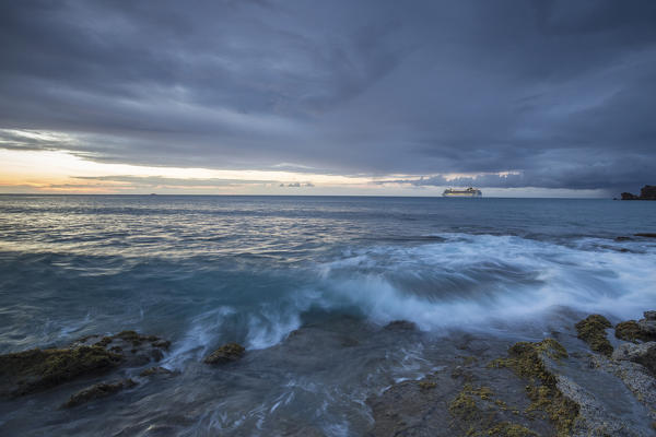 Dusk frames the waves crashing on the cliffs Galley Bay Caribbean St. John's Antigua and Barbuda Leeward Islands West Indies