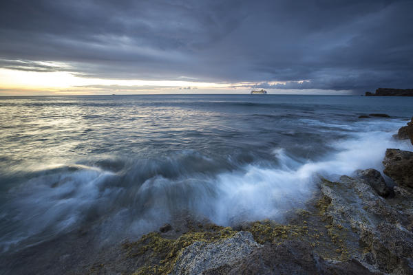 Dusk frames the waves crashing on the cliffs Galley Bay Caribbean St. John's Antigua and Barbuda Leeward Islands West Indies