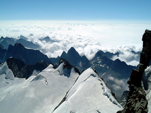 Overlooking the peaks and the fog from the summit of the Gran Paradiso Aosta Valley, Italy Europe