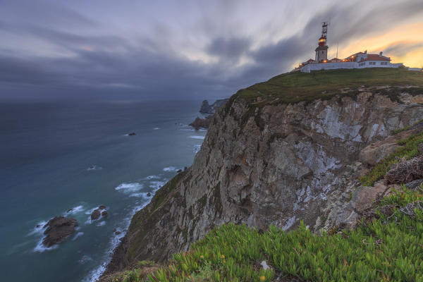 Sunrise on the cape and lighthouse of Cabo da Roca overlooking the Atlantic Ocean Sintra Portugal Europe