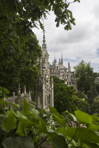 Old mystical buildings of Romanesque Gothic and Renaissance style inside the park Quinta da Regaleira Sintra Portugal Europe