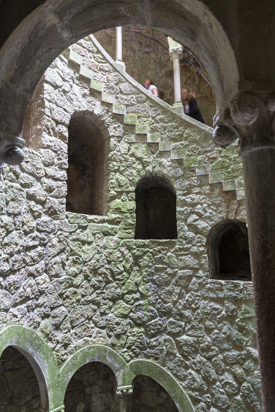 Old mystical buildings of Romanesque Gothic and Renaissance style inside the park Quinta da Regaleira Sintra Portugal Europe