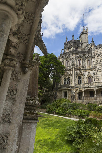 Old mystical buildings of Romanesque Gothic and Renaissance style inside the park Quinta da Regaleira Sintra Portugal Europe