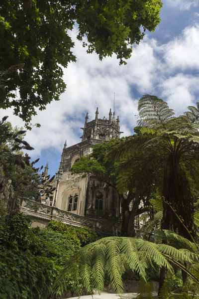 Old mystical buildings of Romanesque Gothic and Renaissance style inside the park Quinta da Regaleira Sintra Portugal Europe