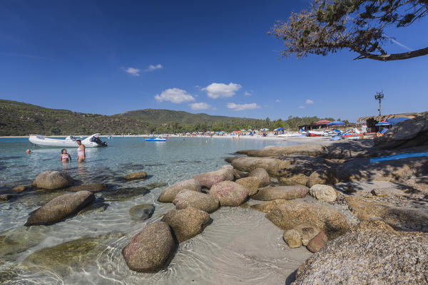 Boats and bathers in the turquoise sea around the sandy beach of Cala Pira Castiadas Cagliari Sardinia Italy Europe