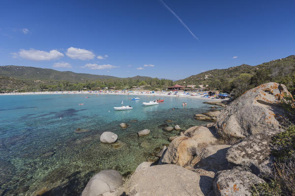 Boats and bathers in the turquoise sea around the sandy beach of Cala Pira Castiadas Cagliari Sardinia Italy Europe