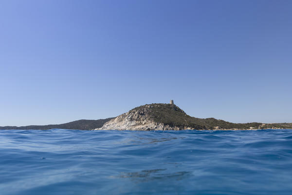 Stone tower on the cliffs surrounded by the blue sea Porto Giunco Villasimius  Cagliari Sardinia Italy Europe